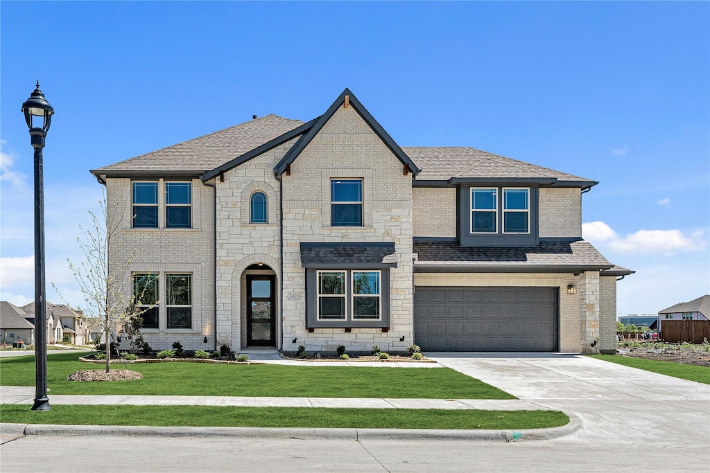 3420 Abingdon Dr, Melissa, TX 75454 - french country inspired facade with a garage, a shingled roof, brick siding, driveway, and a front lawn