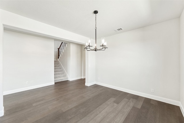 unfurnished dining area with baseboards, visible vents, stairway, and dark wood-type flooring