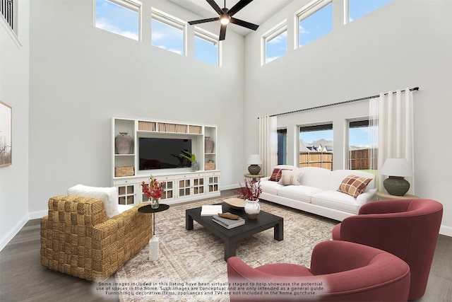 living area featuring a ceiling fan, a high ceiling, baseboards, and wood finished floors