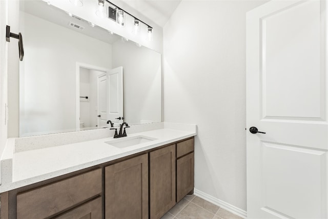 bathroom with tile patterned flooring, visible vents, baseboards, and vanity