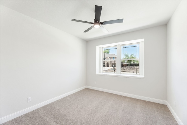 empty room featuring light carpet, ceiling fan, and baseboards