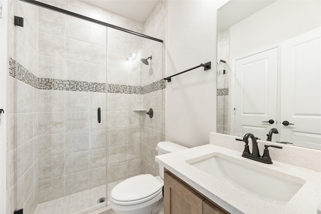 full bath featuring toilet, a shower stall, and vanity