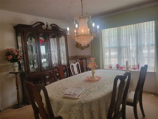 carpeted dining room with a notable chandelier, a textured ceiling, and a healthy amount of sunlight