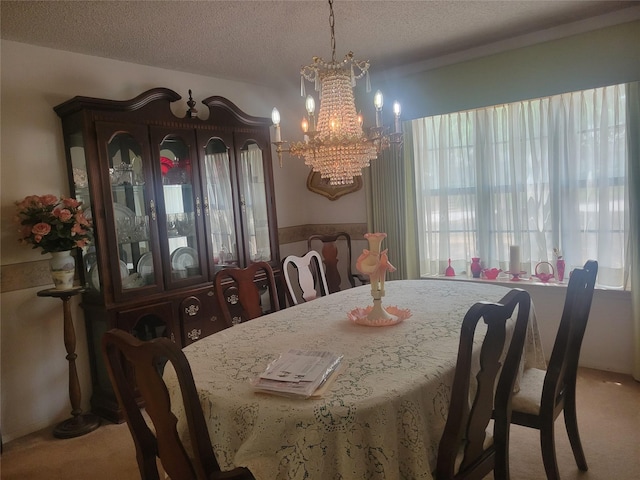 carpeted dining area featuring a textured ceiling and an inviting chandelier