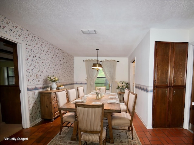 1505 S Rodgers Dr, Graham, TX 76450 - dining area featuring wallpapered walls, baseboards, and a textured ceiling