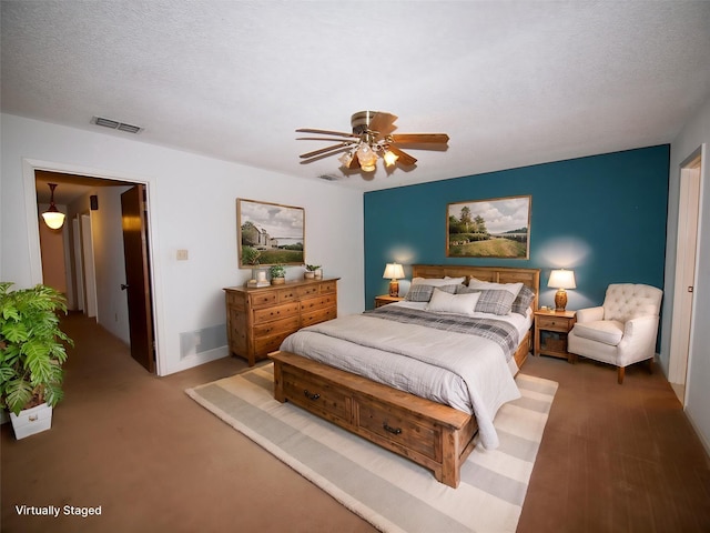 1505 S Rodgers Dr, Graham, TX 76450 - carpeted bedroom featuring ceiling fan, baseboards, and a textured ceiling