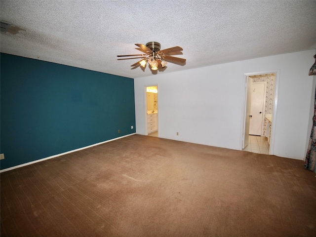 1505 S Rodgers Dr, Graham, TX 76450 - unfurnished room with carpet flooring, a ceiling fan, and a textured ceiling