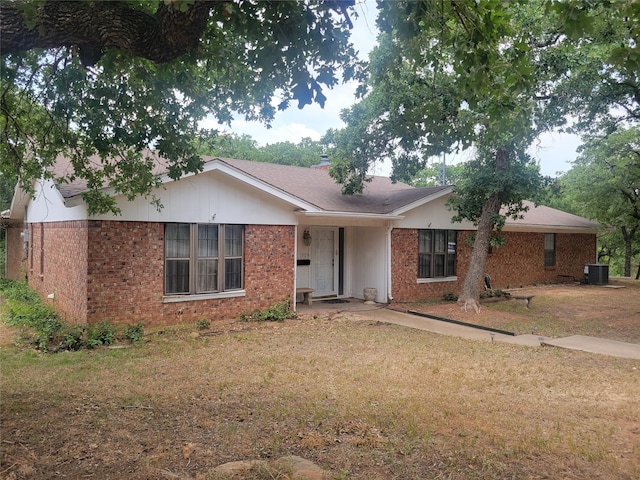 single story home featuring central AC unit and a front lawn