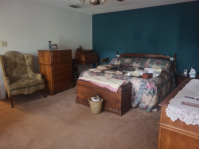 bedroom with ceiling fan, a textured ceiling, and carpet