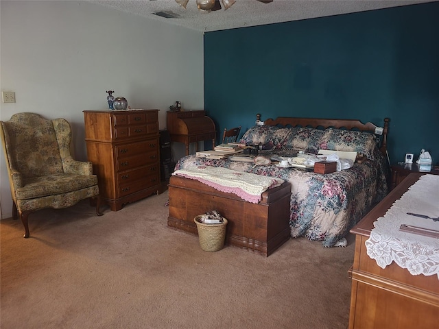 bedroom with ceiling fan, light carpet, a textured ceiling, and visible vents