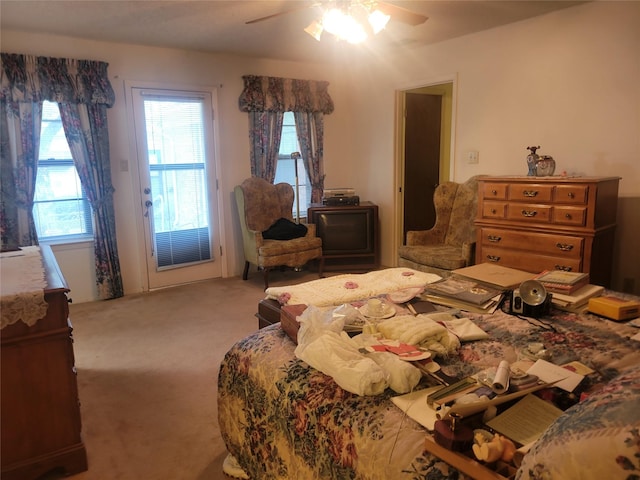 carpeted bedroom featuring a ceiling fan and access to exterior
