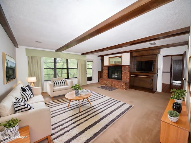 1505 S Rodgers Dr, Graham, TX 76450 - living area featuring beam ceiling, a brick fireplace, and carpet