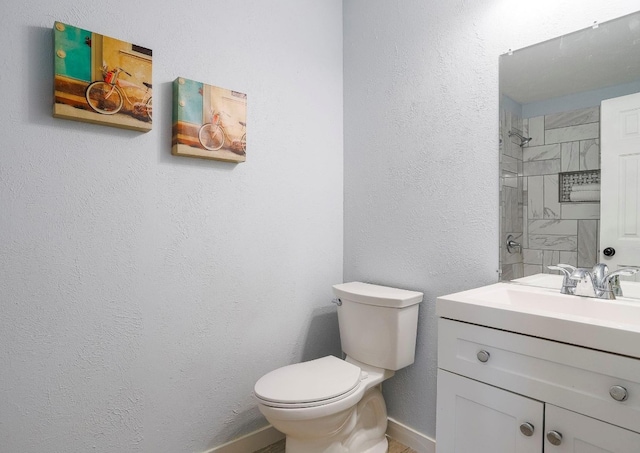 bathroom with large vanity and toilet