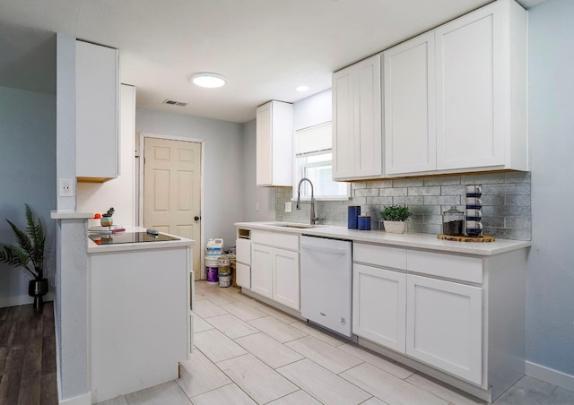 kitchen featuring sink, white dishwasher, backsplash, and white cabinets