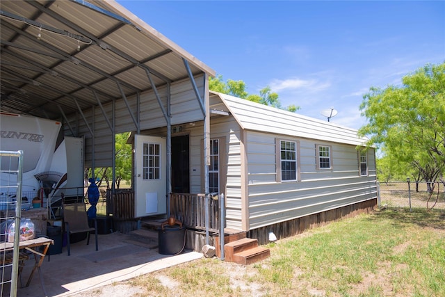 exterior space with a yard and a carport