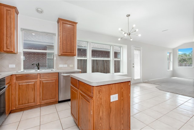 kitchen with sink, pendant lighting, dishwasher, a chandelier, and a kitchen island