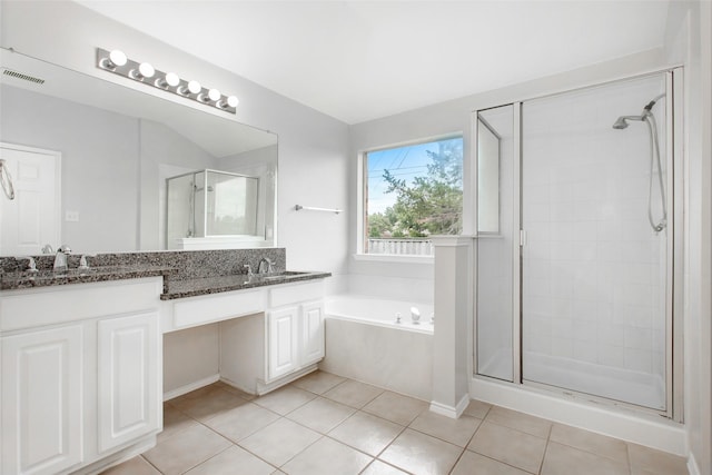 bathroom featuring tile patterned flooring, vanity, and shower with separate bathtub