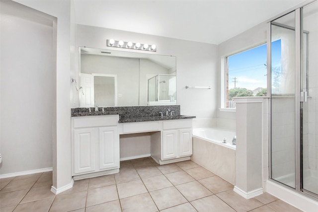 bathroom with tile patterned floors, plus walk in shower, and vanity