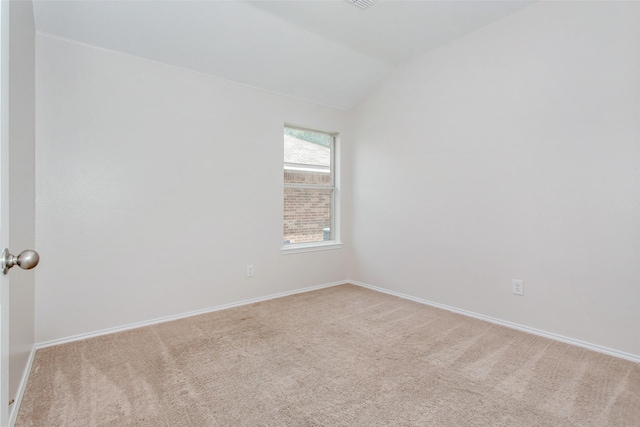 unfurnished room featuring carpet flooring and vaulted ceiling