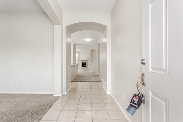 hall with light colored carpet