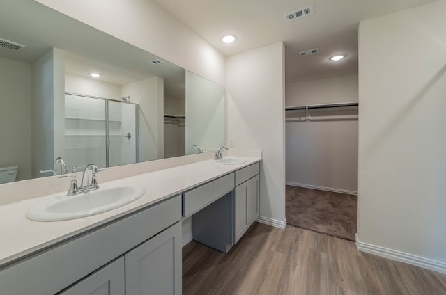 bathroom featuring double vanity and hardwood / wood-style flooring