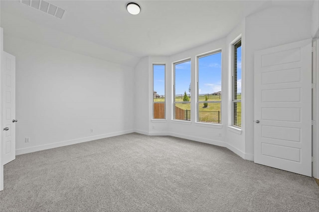 spare room featuring light colored carpet