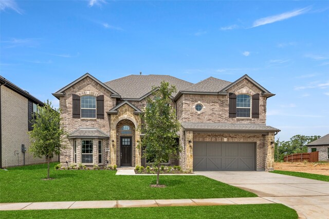 view of front of property featuring a garage and a front yard