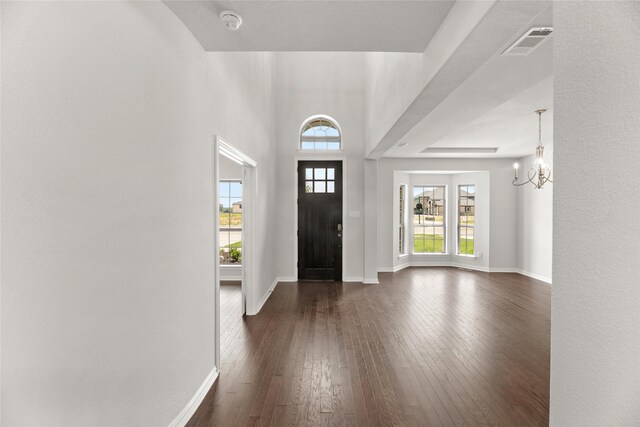 entryway featuring dark hardwood / wood-style flooring and a chandelier