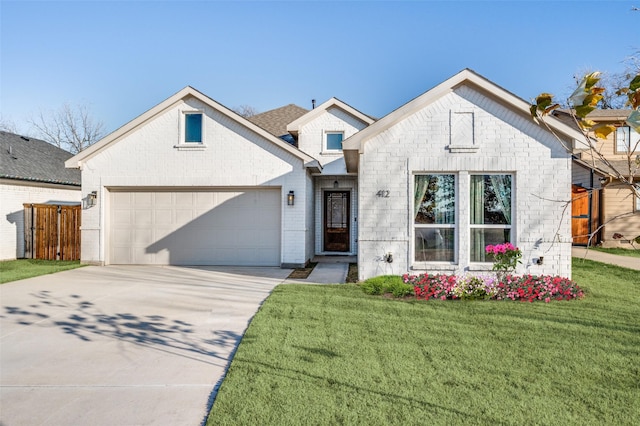 view of front of property with driveway, a garage, a front lawn, and brick siding