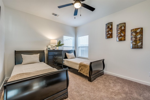 bedroom with carpet, visible vents, ceiling fan, and baseboards