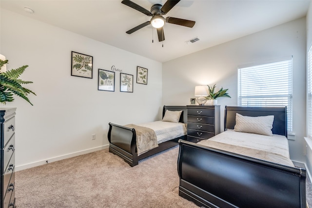 bedroom with baseboards, visible vents, ceiling fan, and carpet flooring