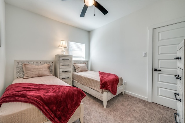 bedroom with ceiling fan, baseboards, and carpet flooring