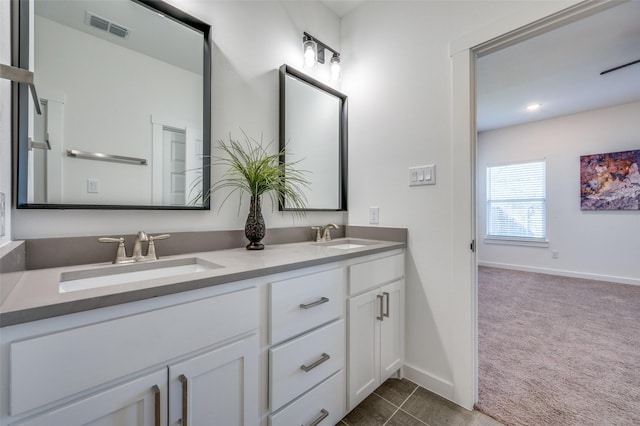 full bathroom featuring visible vents, a sink, baseboards, and double vanity