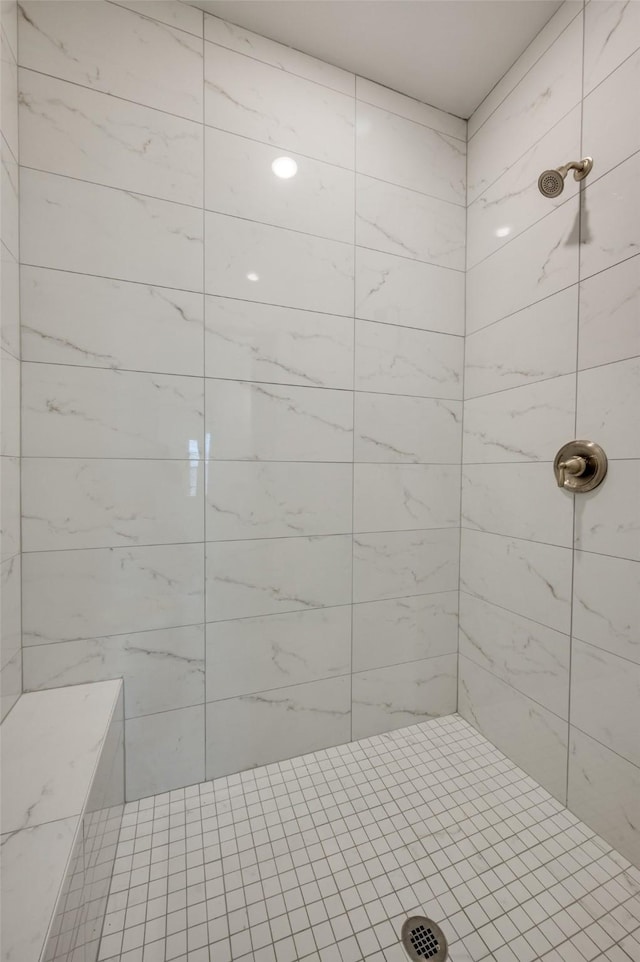 bathroom with a tile shower