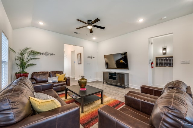 living room with light wood-style flooring, recessed lighting, a ceiling fan, visible vents, and vaulted ceiling