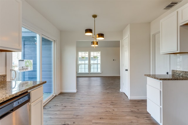 kitchen featuring an inviting chandelier, dark stone counters, light hardwood / wood-style floors, and dishwasher