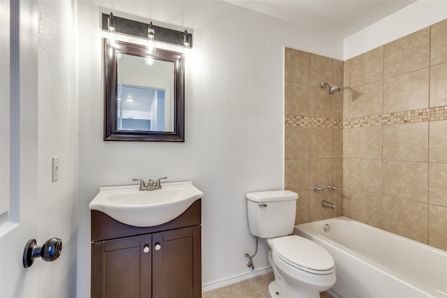 full bathroom featuring tile flooring, toilet, tiled shower / bath combo, and vanity