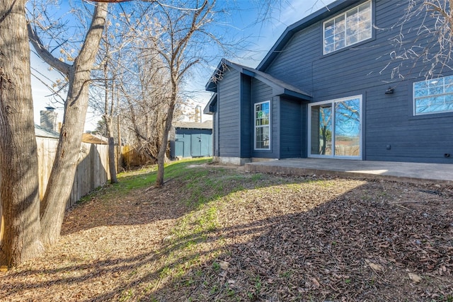 exterior space featuring a patio and a shed