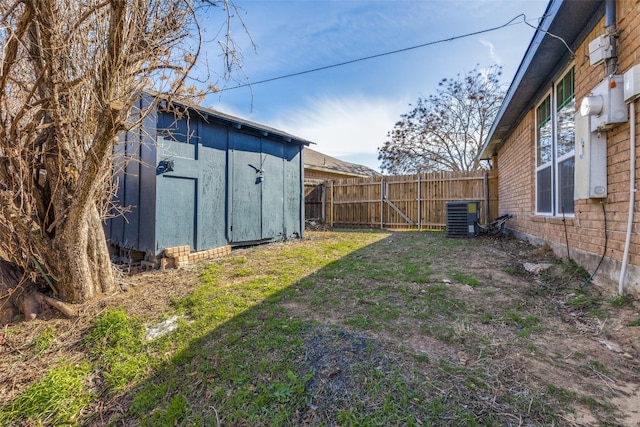 view of yard with central AC unit and a storage unit