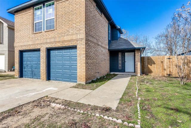 view of side of property with a lawn and a garage