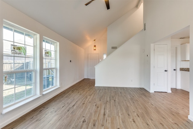 interior space featuring high vaulted ceiling, light hardwood / wood-style floors, and ceiling fan