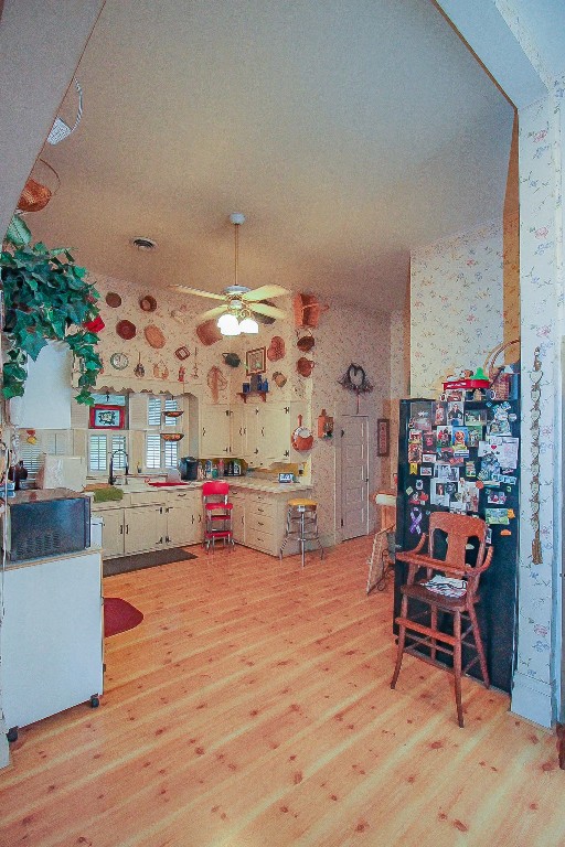 kitchen featuring ceiling fan and light hardwood / wood-style floors