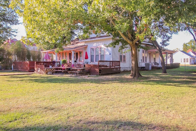 view of front facade featuring a deck and a front lawn