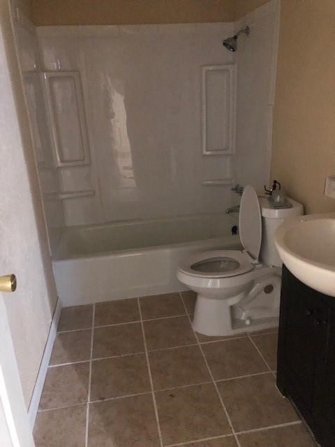 full bathroom with tile floors, toilet, vanity, and shower / bath combination