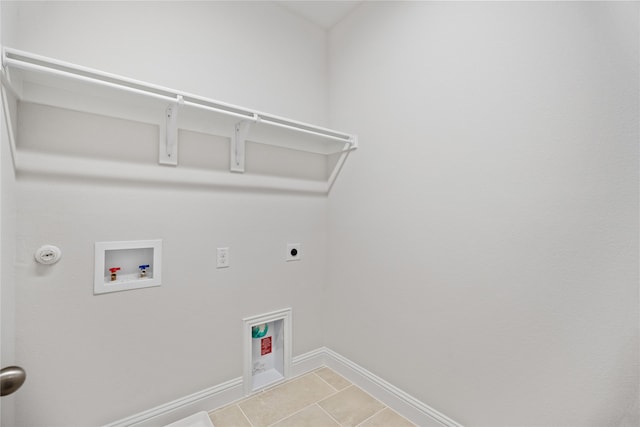 washroom with hookup for a gas dryer, light tile patterned floors, hookup for an electric dryer, and hookup for a washing machine