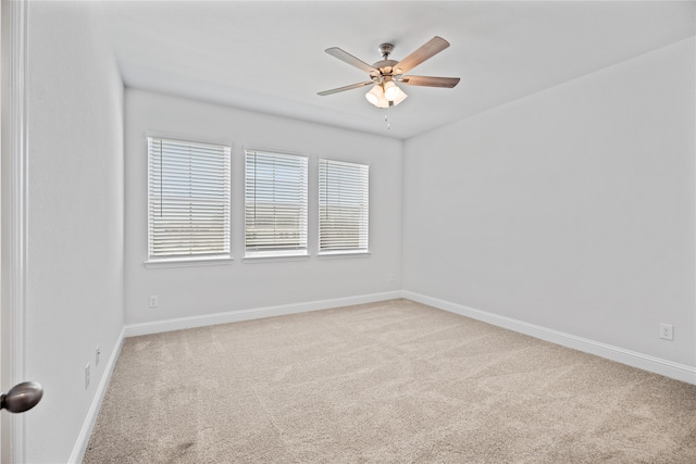 unfurnished room with ceiling fan and carpet flooring