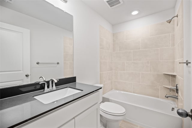 bathroom featuring visible vents, toilet, shower / washtub combination, and vanity