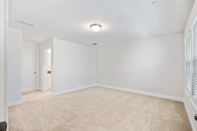 unfurnished room with light colored carpet