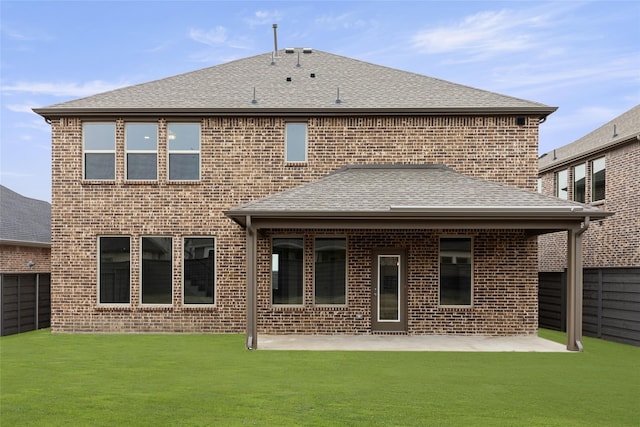 back of house featuring a yard and a patio area