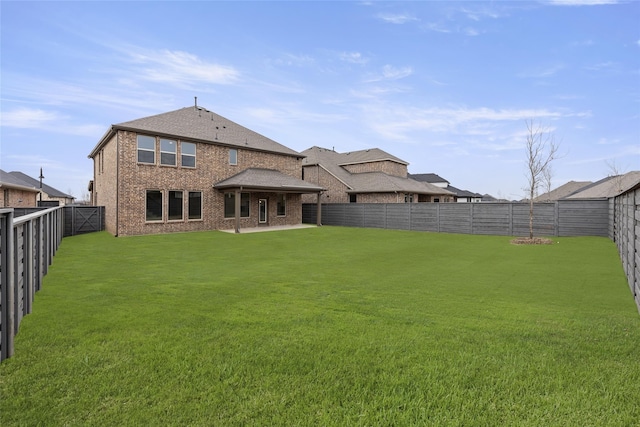 rear view of house featuring a lawn